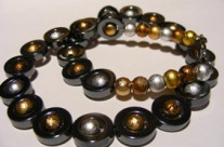 Hematite donuts filled with metallic coated glass