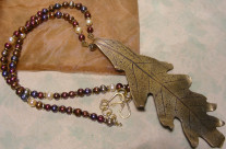 Long brass oak leaf pendant