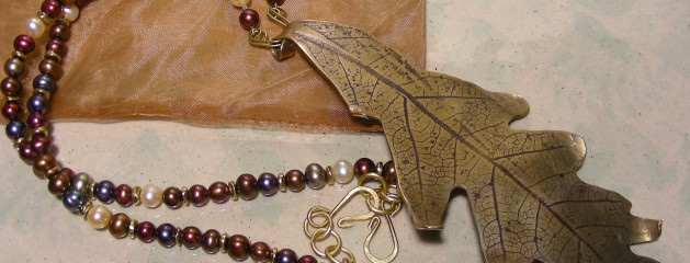 Long brass oak leaf pendant